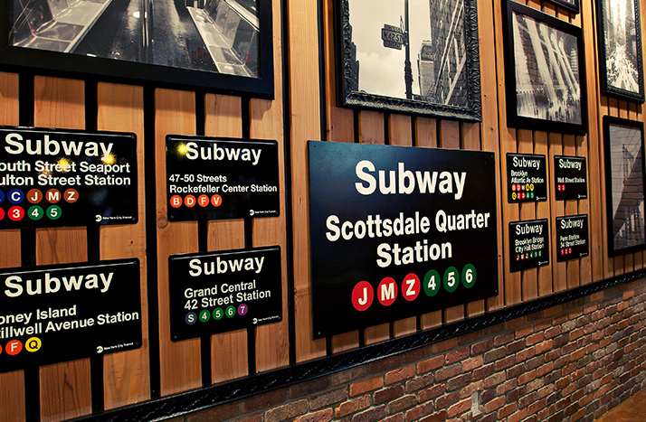 Slices Pizzeria.com interior wall with various framed pictures.